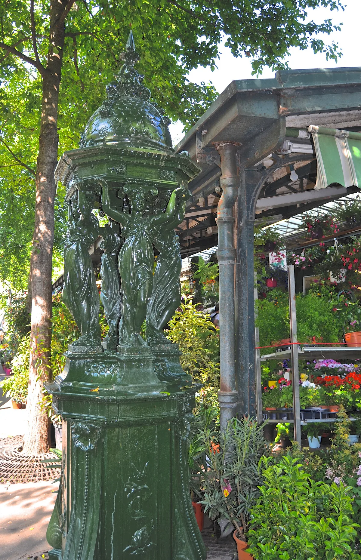 Fontaine Wallace en fonte verte, sculpture urbaine du XIXe siècle dans une rue de Paris